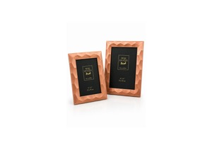 Copper geometric frames on white surface